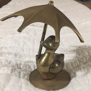 Bronze duck under umbrella